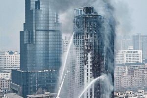 This Photo Taken On March 9, 2021 Shows Firefighters Attempting To Put Out A Fire In A 26-storey Building In Shijiazhuang, In China's Northern Hebei Province. (Photo By - / AFP) / China OUT